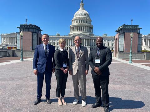 STS members (Patrick Roughneen, MD, Carrie Dubeau, MD, John Calhoon, MD, and Louis Clauden, MD) in front of the Capitol building during the 2022 STS Advocacy Conference